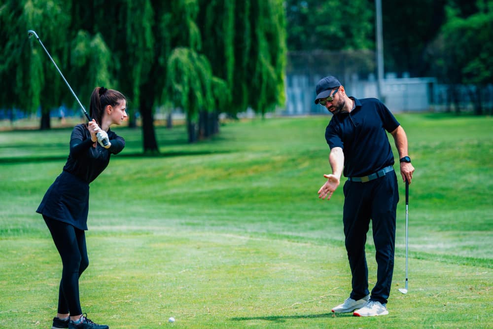 Coach and student on Westfield's creek-side course